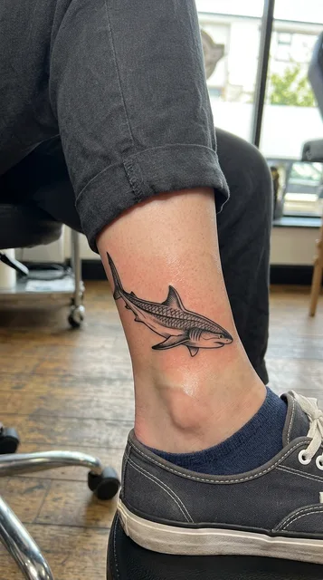Shark tattoo on the ankle