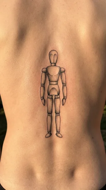 Black and grey dotwork mannequin tattoo on a man's back