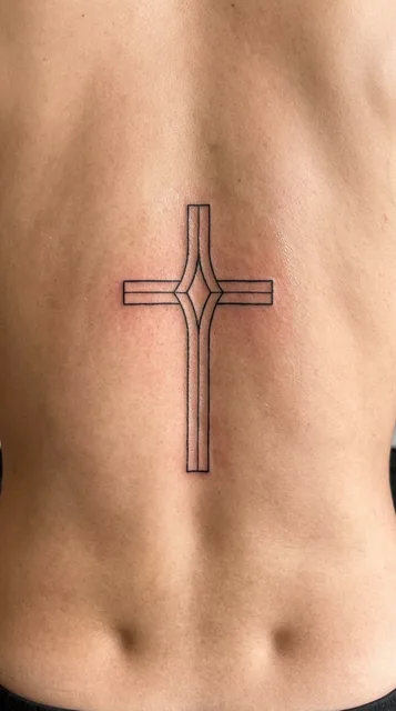 Black and white linework cross tattoo on a man's back