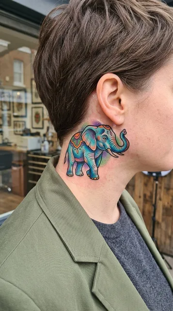 Color new school elephant tattoo behind a woman's ear