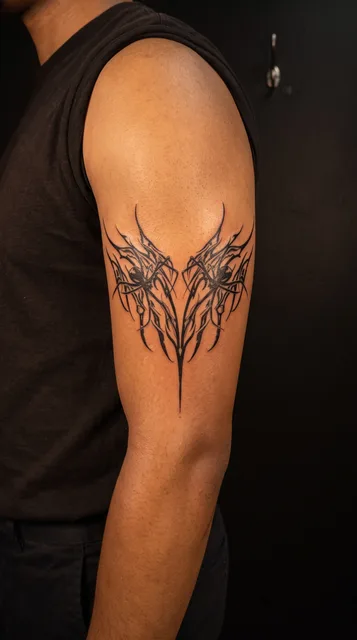 Black and white tribal ornament tattoo on a man's bicep