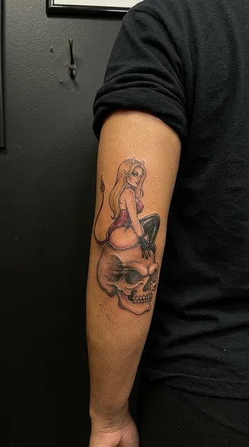 Color neo traditional skull tattoo on a woman's elbow