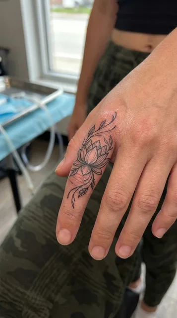 Lotus tattoo on the finger