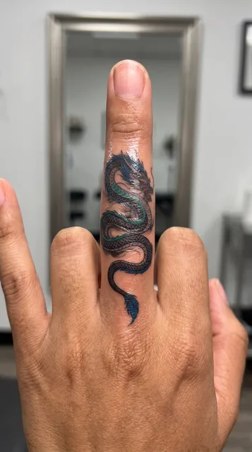 Color Japanese dragon tattoo on a man's finger