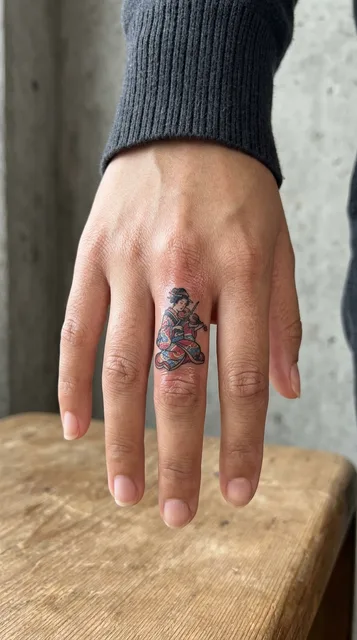 Color Japanese tattoo on a woman's finger