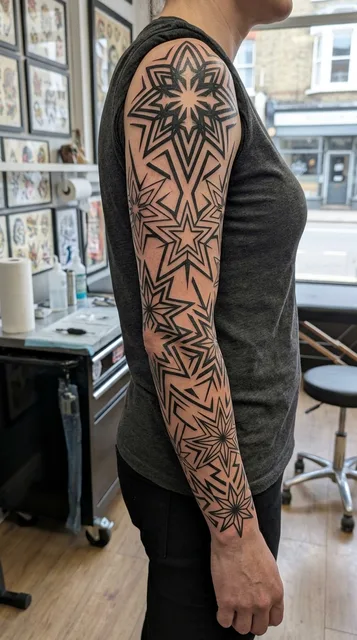 Black and white tribal ornament tattoo as a full sleeve on a woman