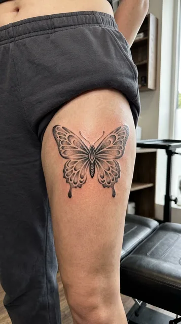Butterfly tattoo on the thigh