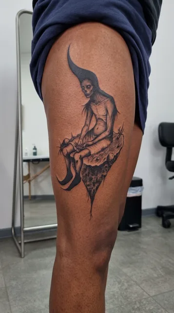 Black and grey dotwork figure tattoo on a woman's thigh