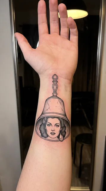 bell tattoo on the wrist