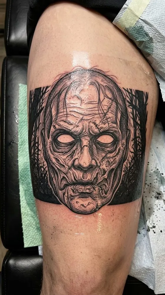 Zombie face portrait, black and grey tattoo preview on an upper arm